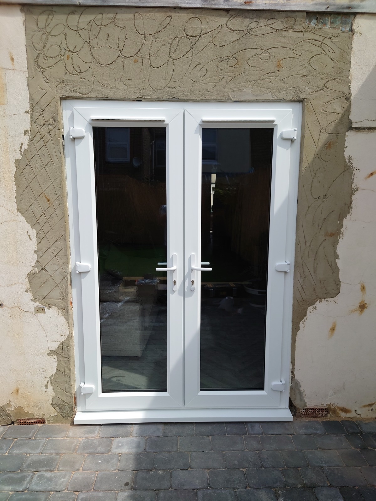 French doors fitted by HDS on a rendered wall
