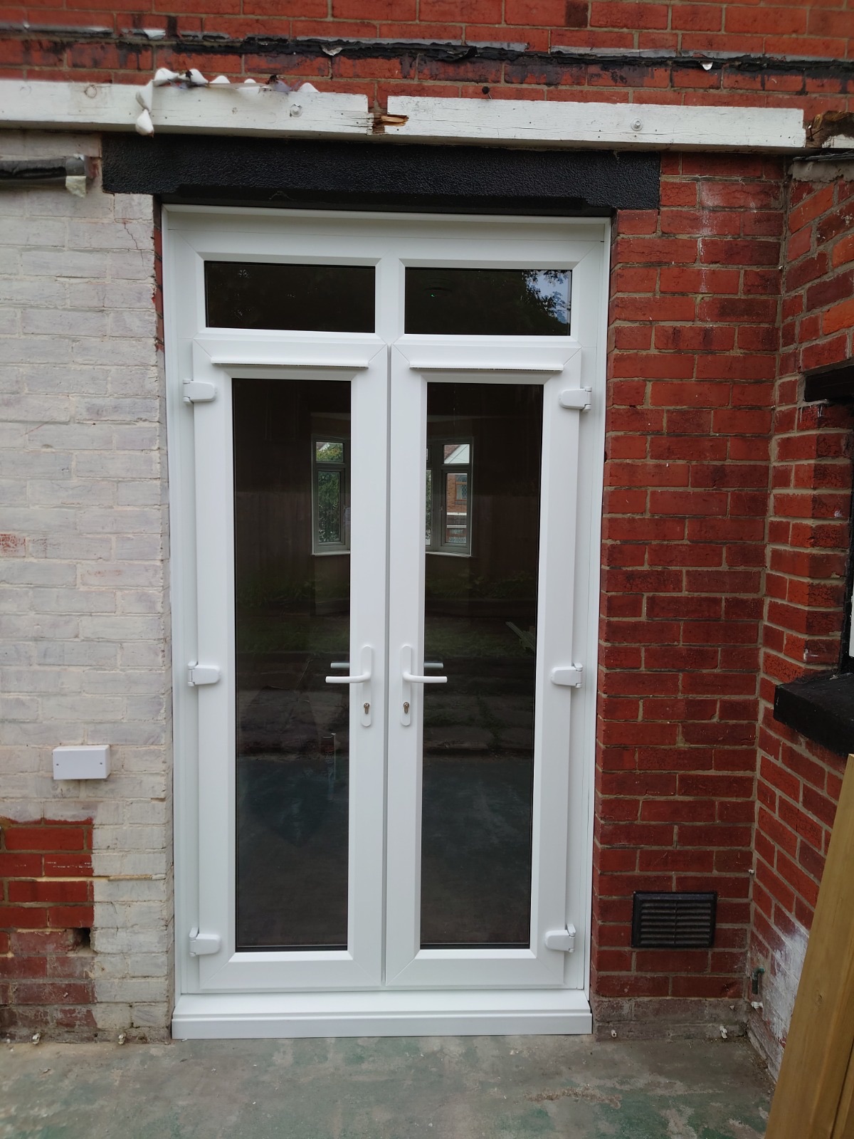 French doors fitted by HDS on a red brick home