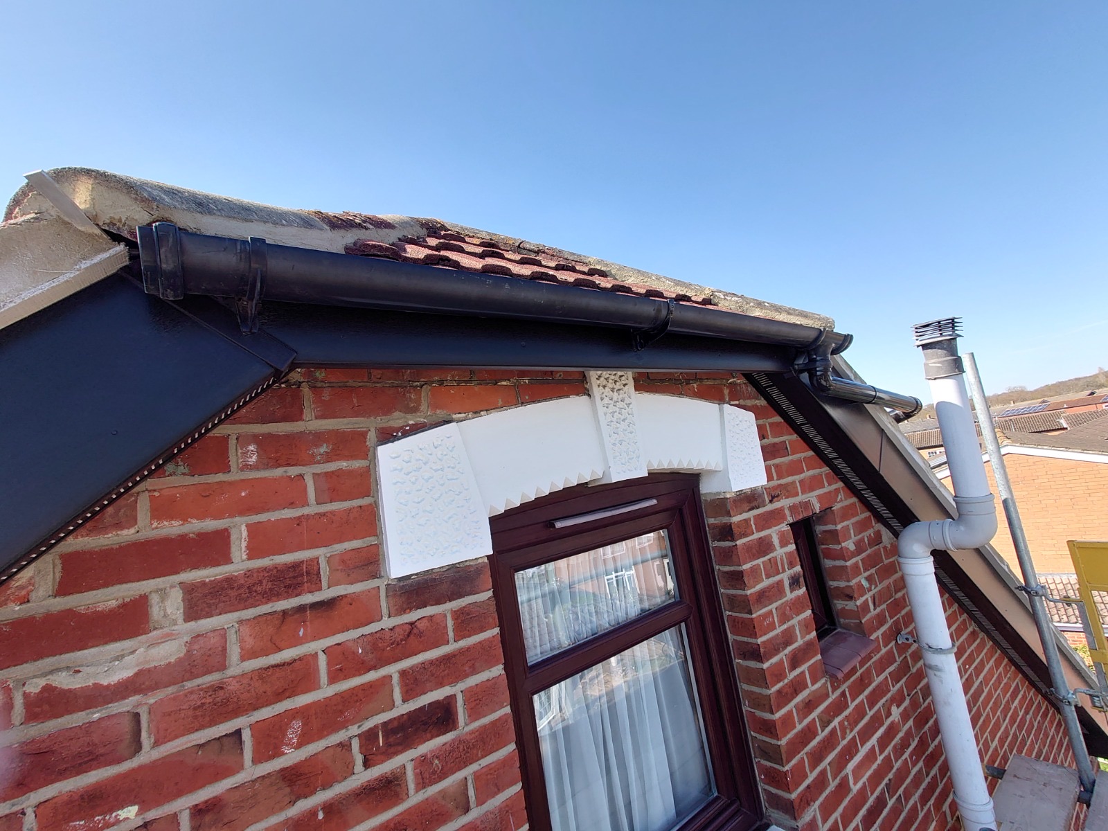 New black uPVC fascia and soffit fitted by HDS against red brick