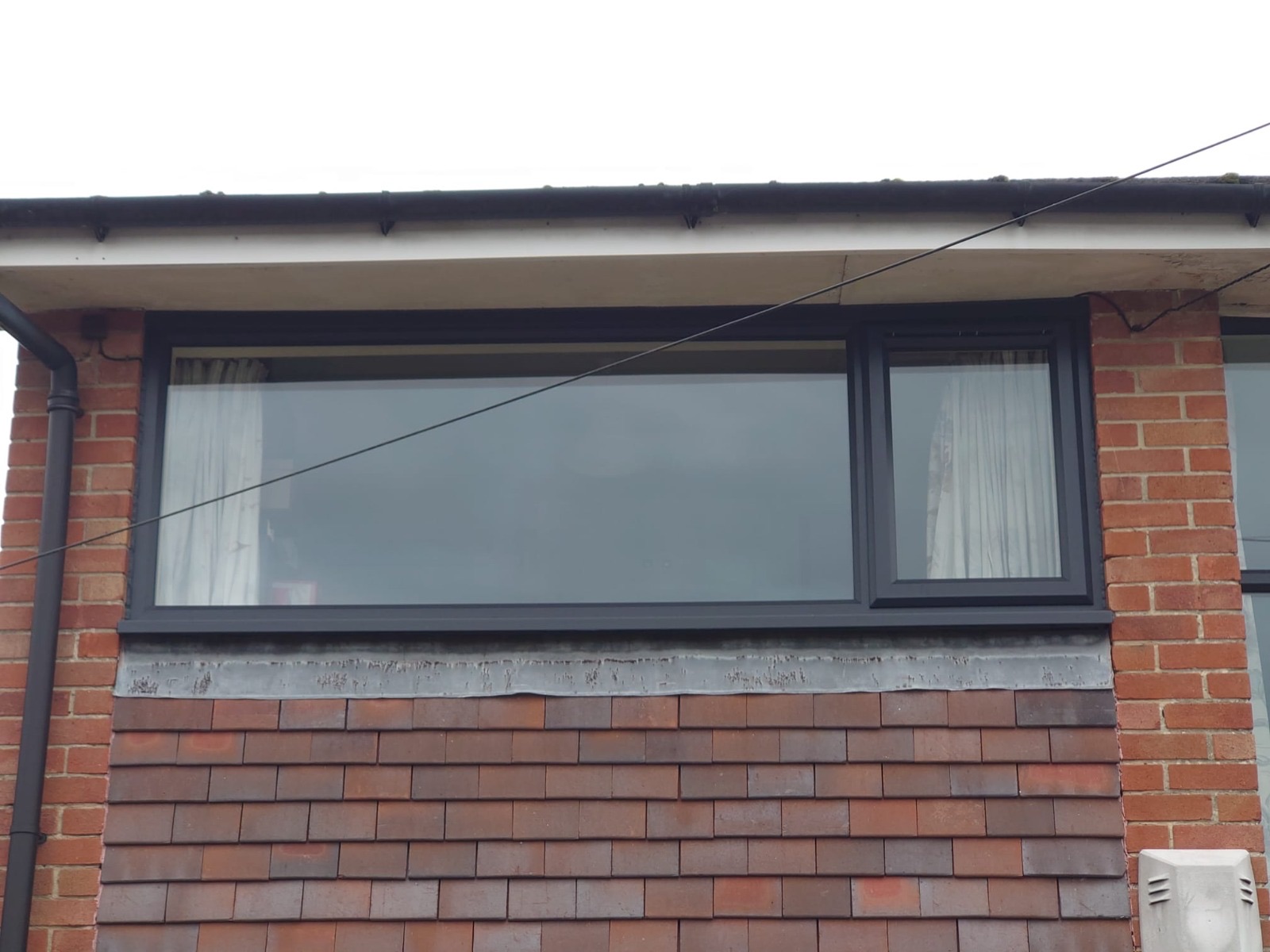 New anthracite uPVC window fitted after brickwork was made good